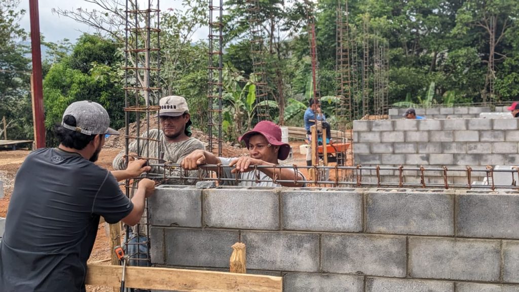 Jota, in the red hat, is now a school-building master.