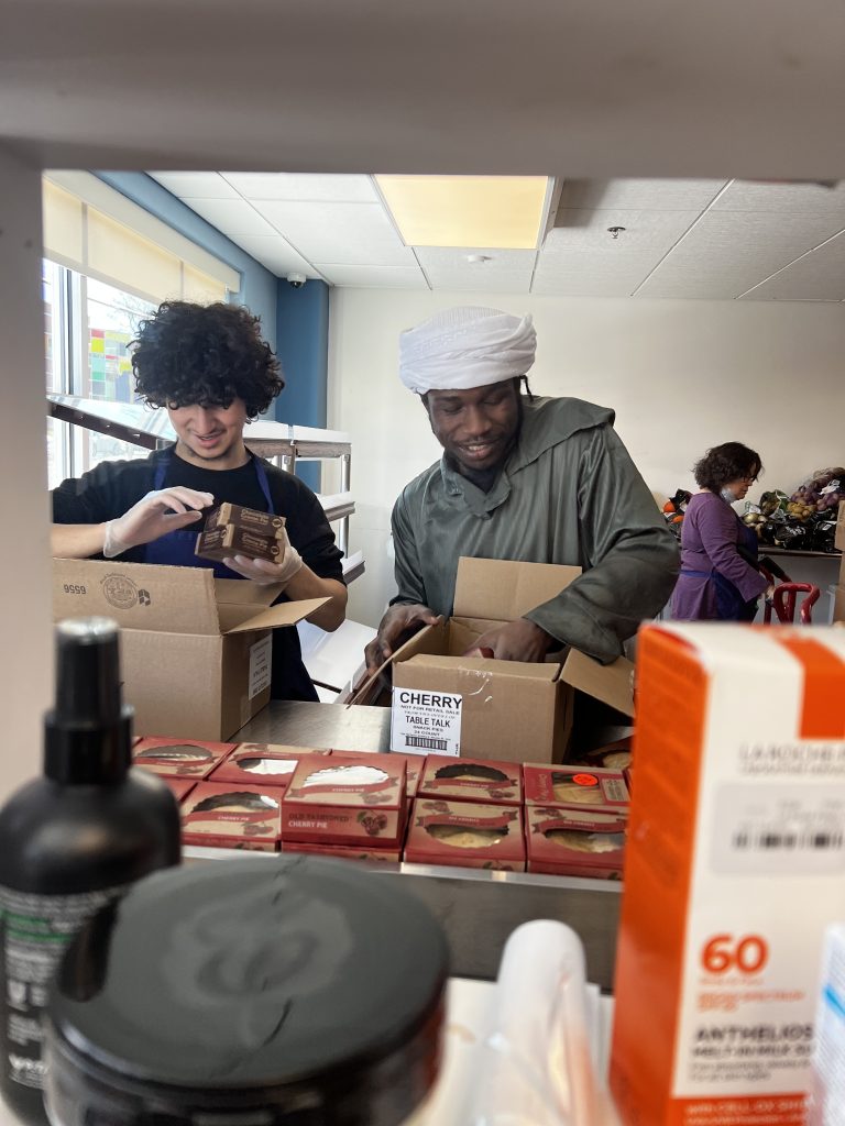 Kenan at service with his buildOn Engagement Specialist Al'Urdun Islam