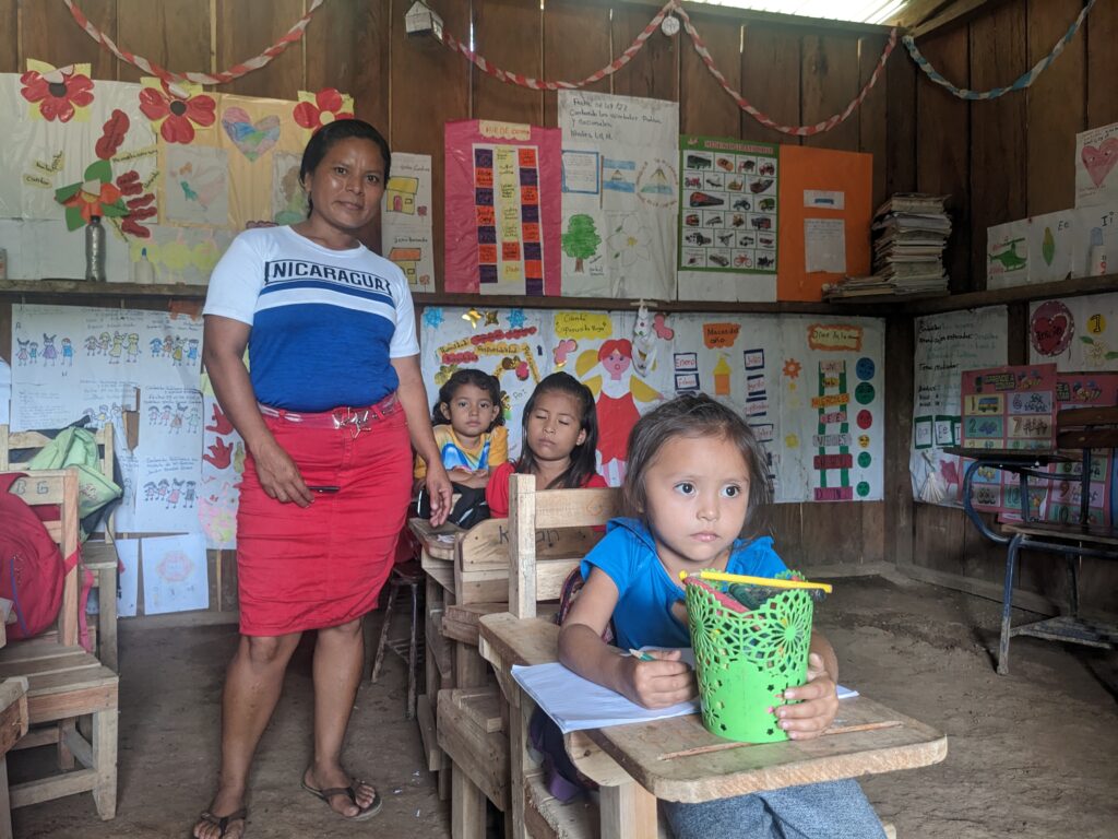 Sandra (pictured standing in the old school) refused to let any obstacles get in the way of her dream of becoming a teacher.