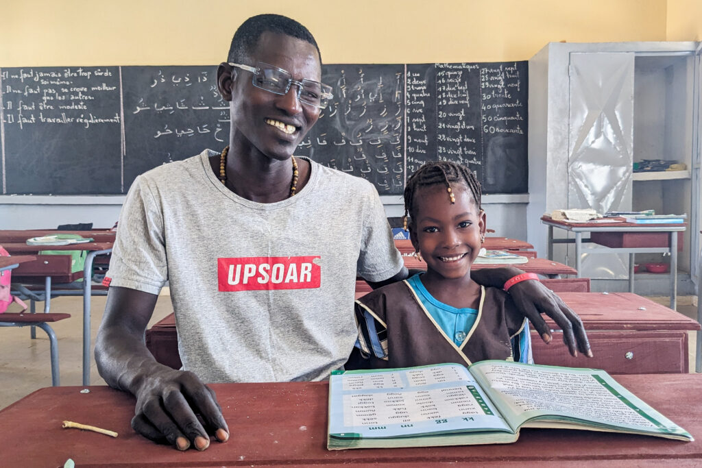 Father and daughter reading in school in Senegal.