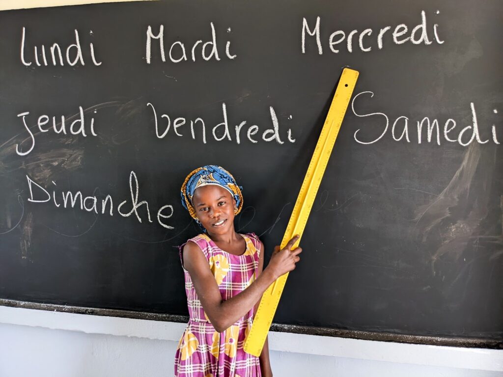 A young girl in Keur Adama Dia, Senegal attends classes in a school built by buildOn and Circle of Sisterhood.