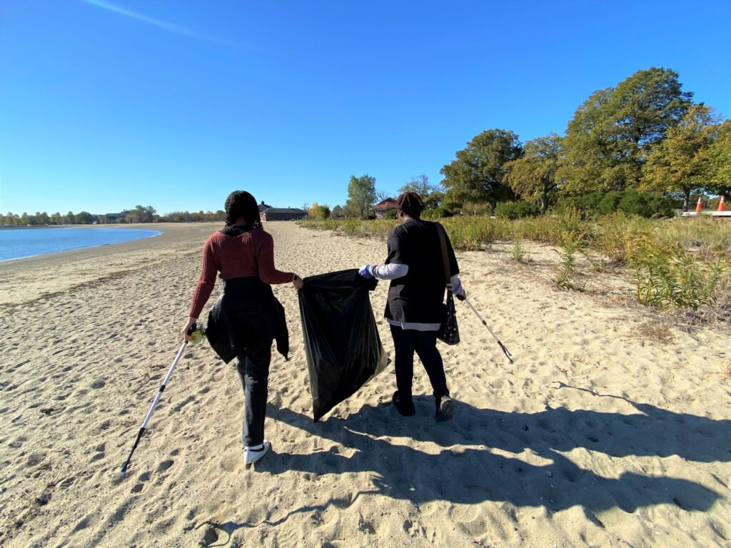 buildOn students in Boston help clean up trash at Carson Beach, a local public beach.