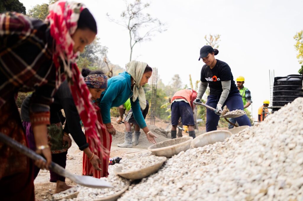 On Trek, participants work side-by-side with community members to build a school.