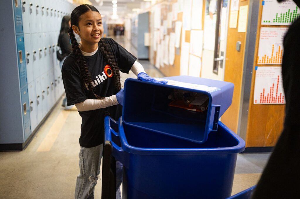 Krystal Khiev helping with a recycling service project at Oakland High School.