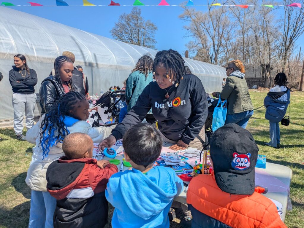 Tae’iona Hill helps Motor City youth with crafts at Pingree Farms’ Easter event.