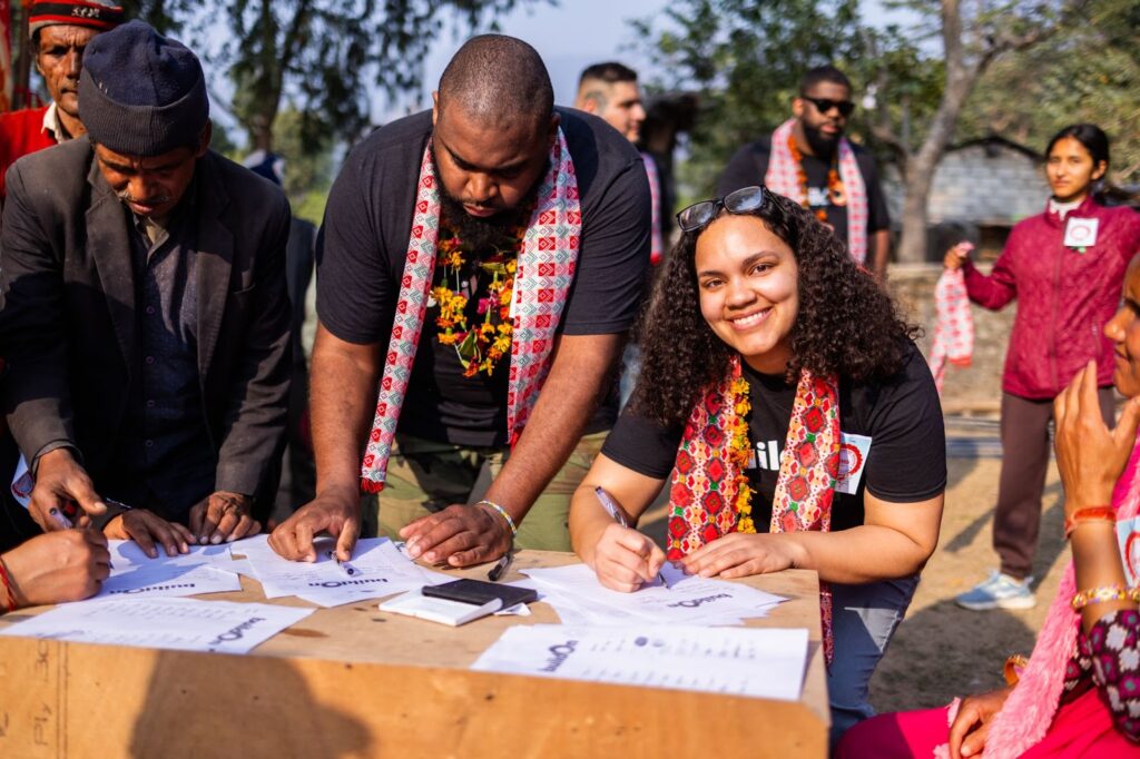 Penelope Bencosme Felipe signs a covenant with the people of Museti at the beginning of her alumni Trek.