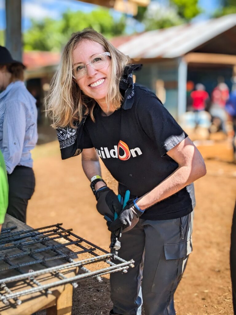Vicky helps to tie rebar for the walls of the new school.