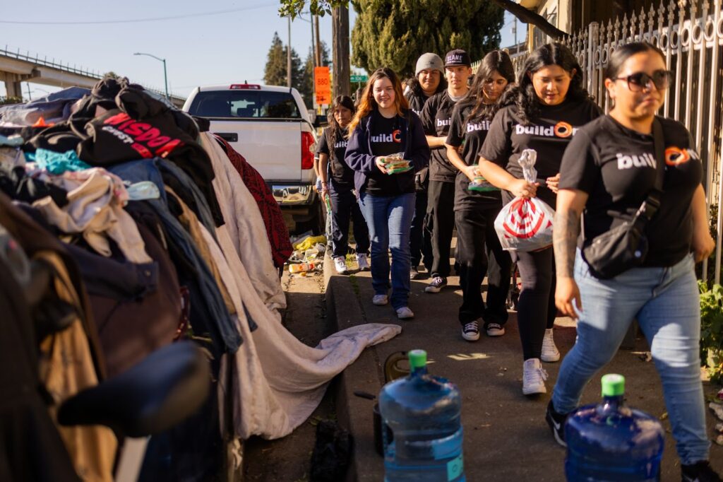 buildOn students in Oakland deliver meals to a homeless encampment.