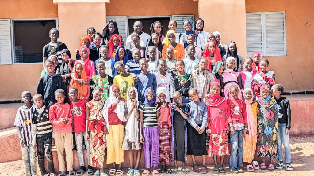 The children of Ndanghar outside of their new school, which Awa played a key role in building.