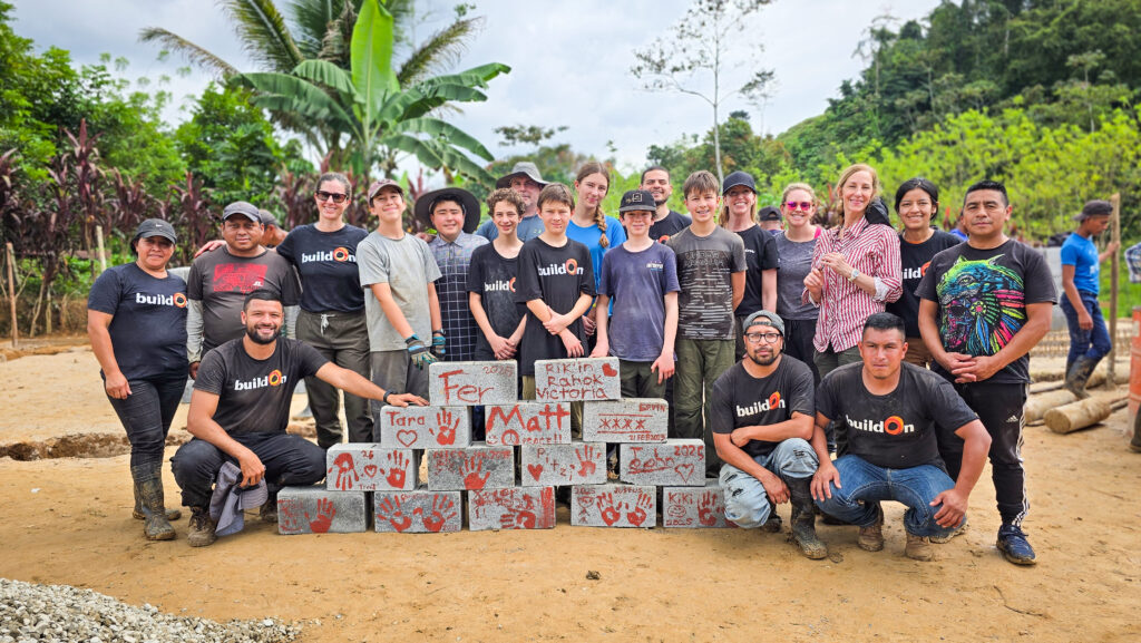 The Helping Hawks Trek Team with specal bricks they've decorated for the new school.