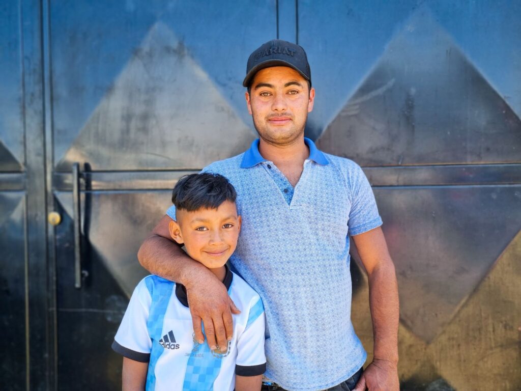 Jonny, pictured here with his father, Gilberto, loves attending school because it means he can play soccer with his classmates.