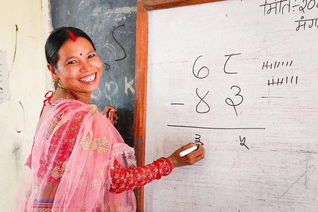 Adult Literacy Program participants, like this woman in Ghusari, learn business skills as well as learning to read, write, and do basic math.