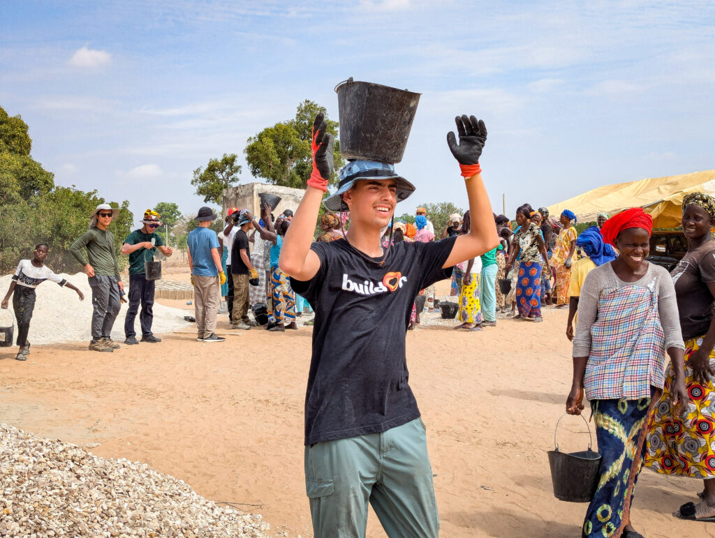 In Senegal, Julian, Aeron, and the rest of their Trek team immersed themselves in the local culture—including learning how to carry buckets on their heads!