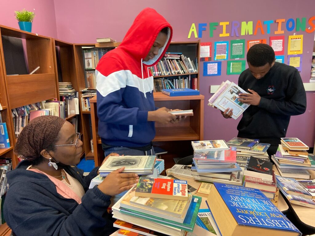 buildOn students in Boston help sort books for donation.
