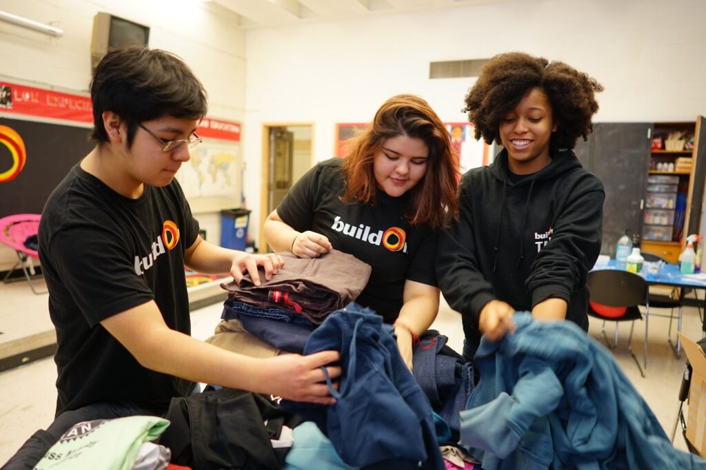buildOn students in Detroit help sort clothing donations.