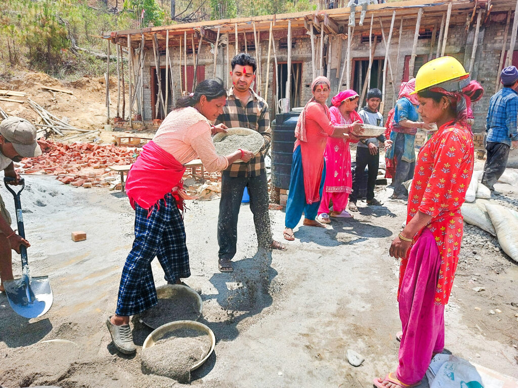 Sangam, pictured here on the worksite, served as president of the school management committee.