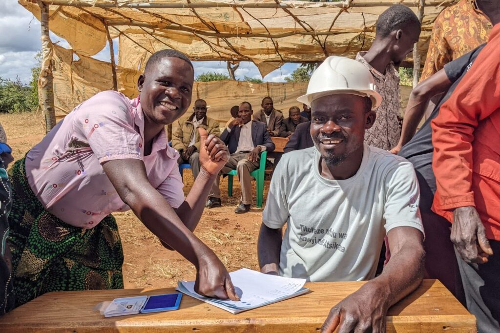 The community of Katope, Malawi, comes together to sign their buildOn covenant.