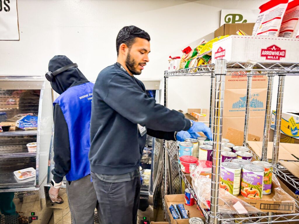 buildOn Engagement Specialist Sebastian Arbelaez helps hand out groceries at PCI Food Pantry.