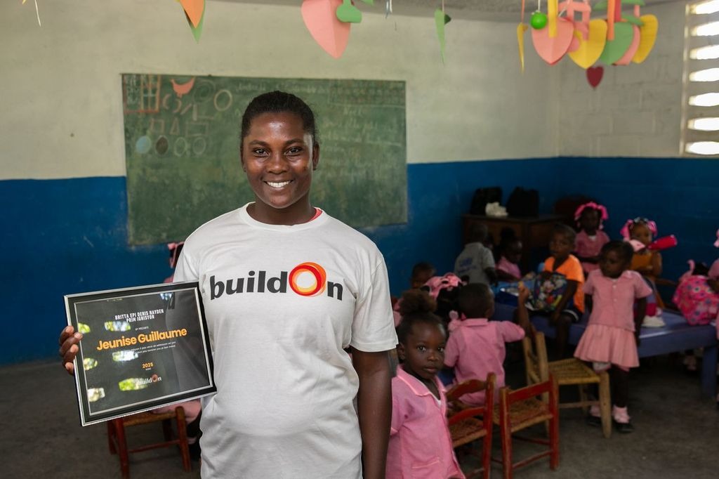 Jeunise stands proudly with her award in the school that changed her life.