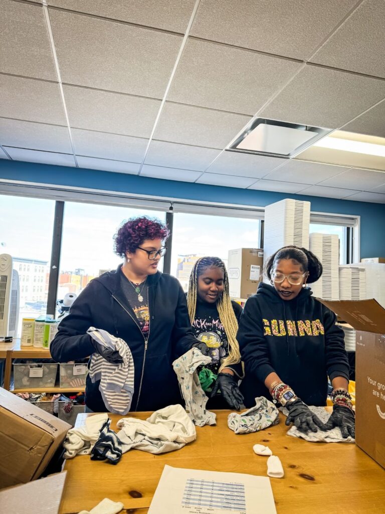 buildOn students in the Bronx help sort clothes at Room to Grow.