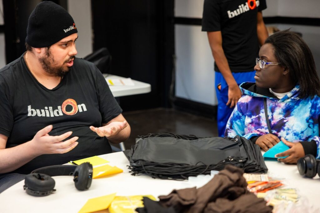 Juan continues to serve with buildOn, like here where he packed winter warming kits for neighbors.