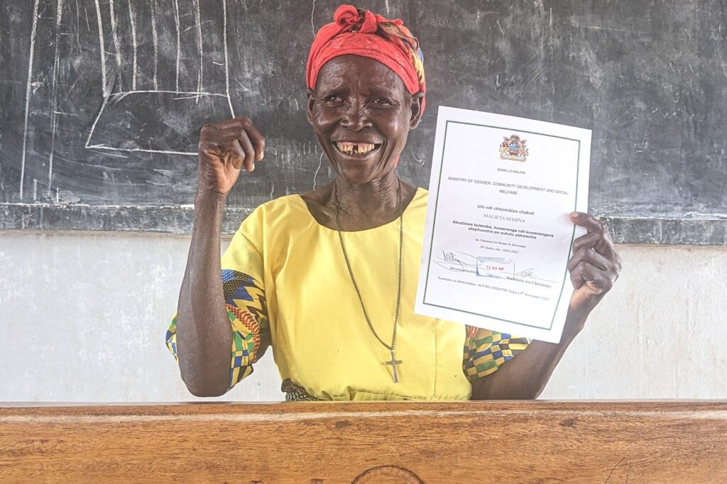 Malieta beams as she graduates from buildOn’s Adult Literacy Program.