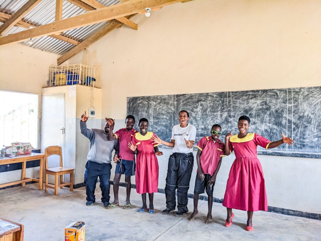 When four students (pictured here) could not afford school uniforms, Ndatuwa’s Project Leadership Committee raised funds to buy them for them.