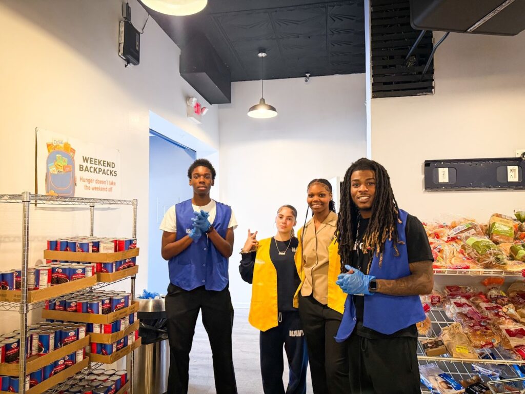 Cedric serving at a food pantry with his students in Bridgeport. “We need to be out there with the people to see what our work is doing,” Cedric says about service.
