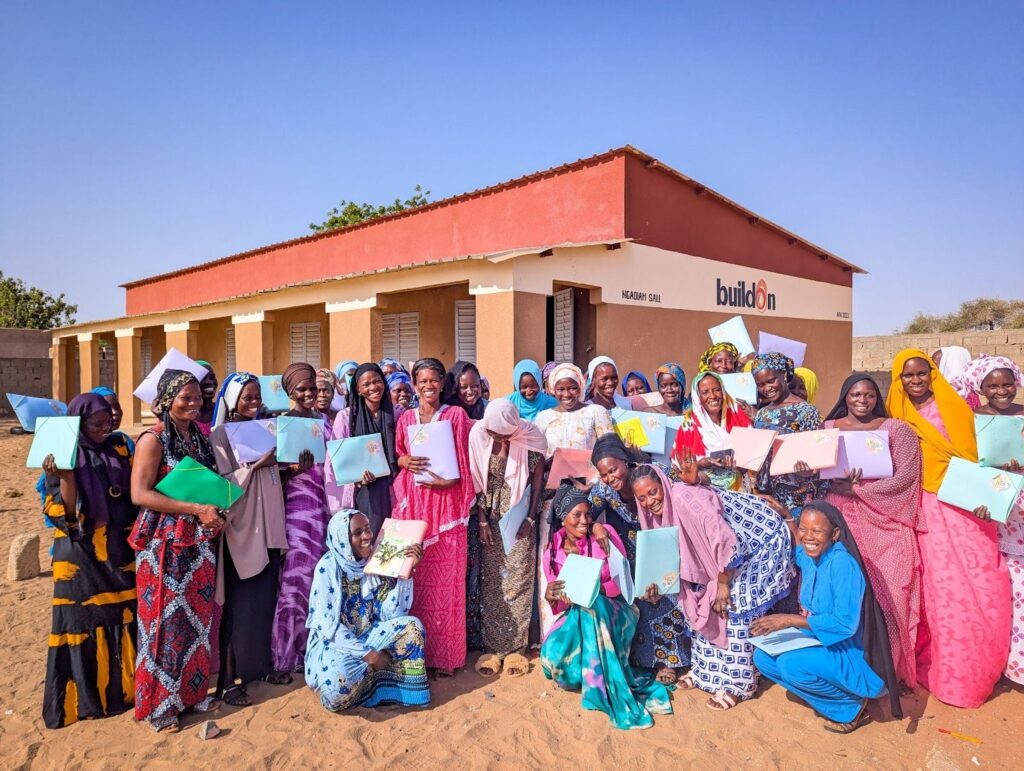 Adult Literacy Program graduates celebrate in front of their buildOn school. This ALP was funded by Fitch.