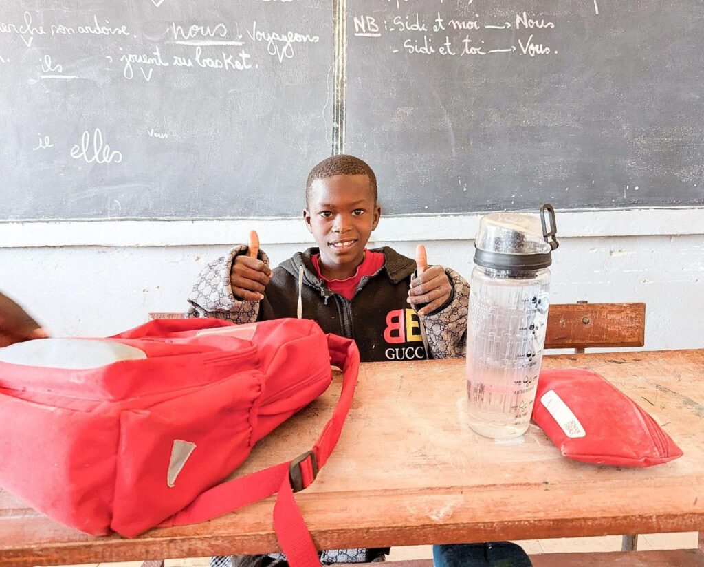 Through the help of buildOn, Fitch, and School in a Bag, Abdou was able to get back into the classroom and stay there.