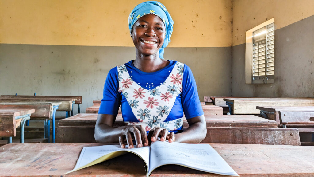 Rokiatou sits in the classroom where she learned to read and write—and changed her own life.
