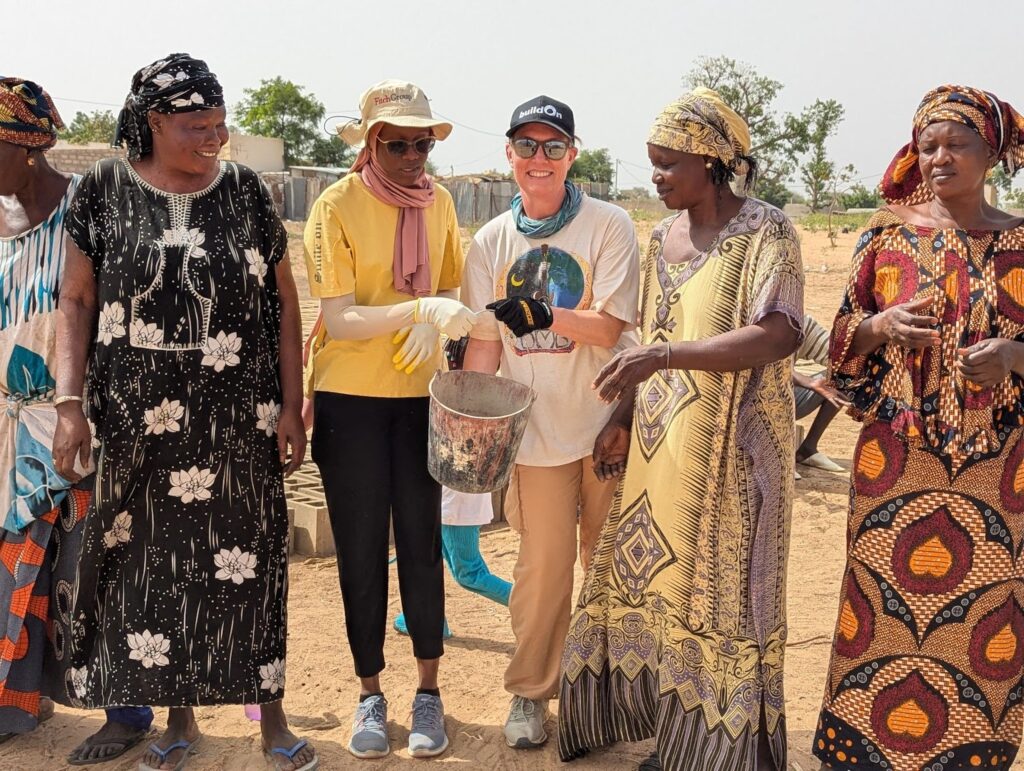 Summer helping to pass buckets of cement in Senegal.