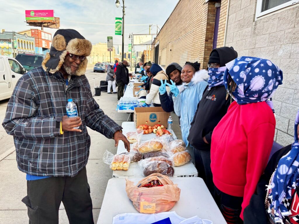 buildOn students hand out homemade food to Detroiters in need through the ARK, a local church.