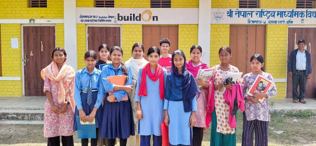 Afrin with her classmates in front of their buildOn school.