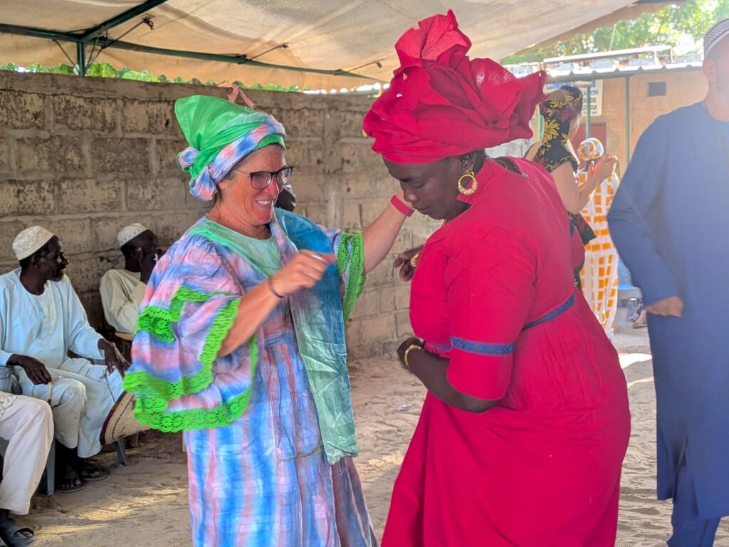 The team danced with community members at the closing ceremony.