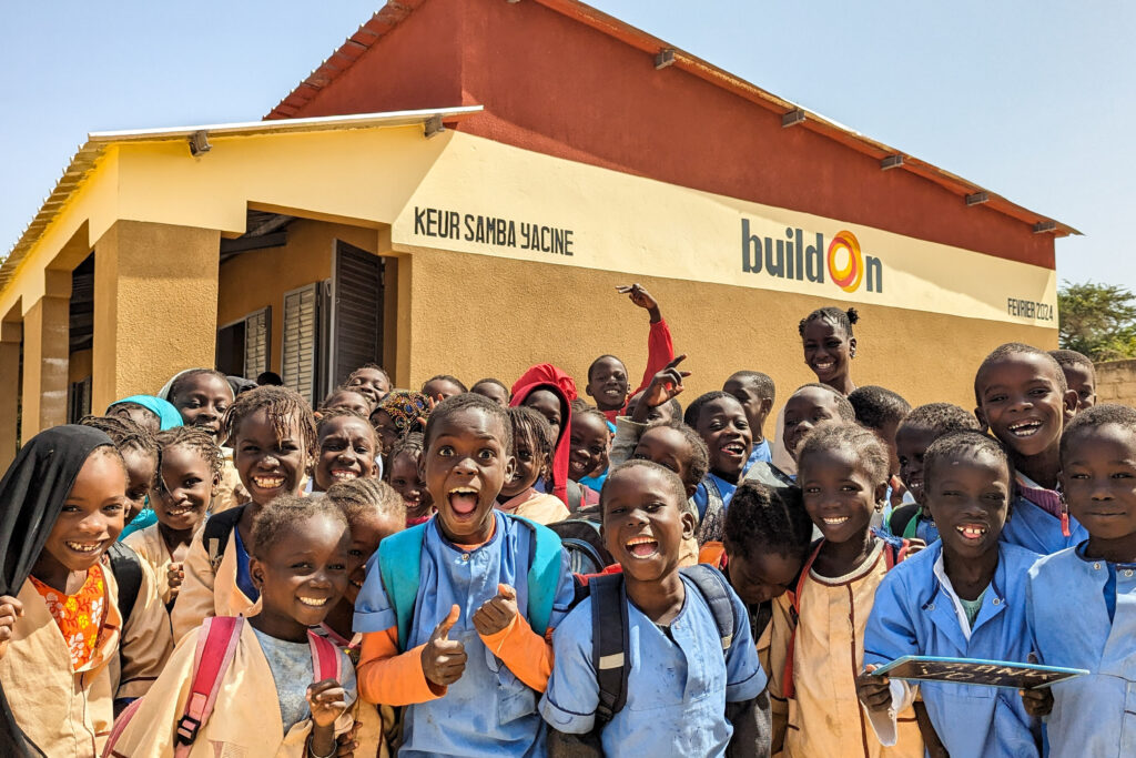 Children celebrate in front of their new buildOn school in Keur Samba Yacine, Senegal.