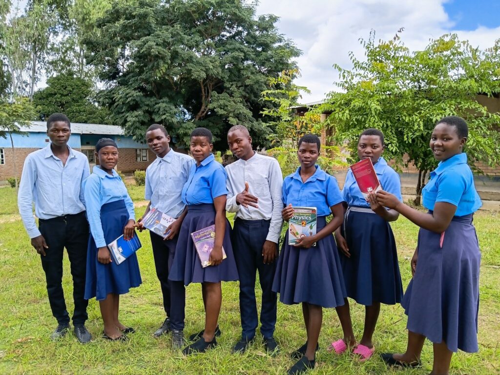 Patrick (center) outside of his secondary school.