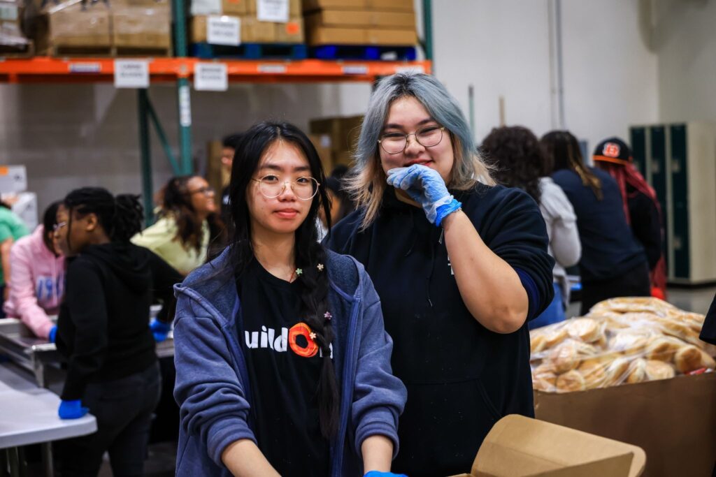 Kelly Luo Melling (left) packing food at the Greater Chicago Food Depository.