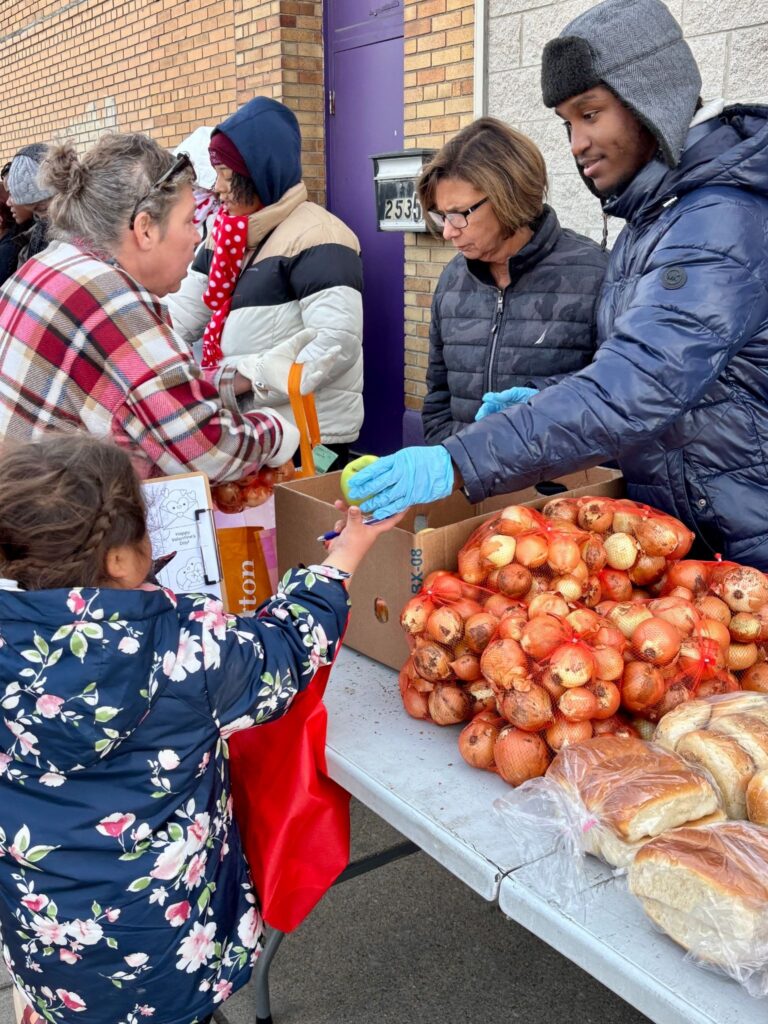 Eric Burnett, president of buildOn’s chapter at East English Village, at service in Detroit.