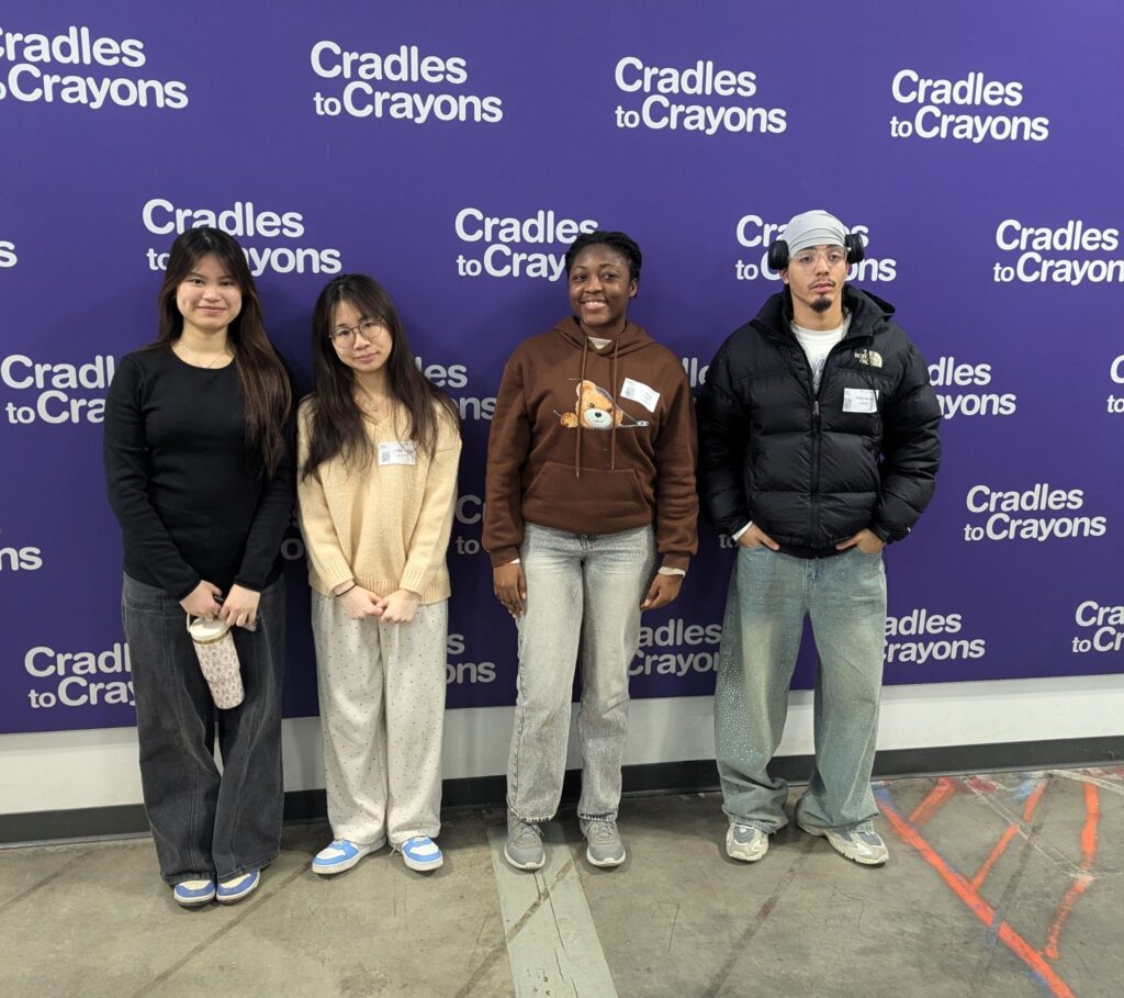 Youselande Charles (second from right) at service with Cradles to Crayons in Boston.