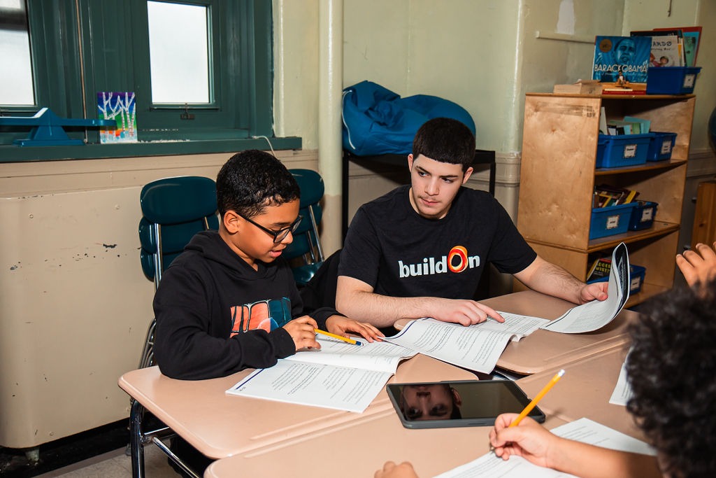 buildOn students frequently help tutor younger children in their communities, like this student at PS35 in the Bronx.