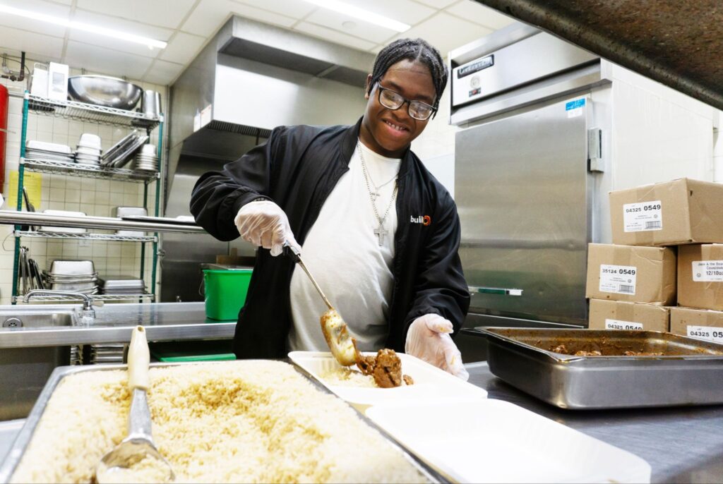 A buildOn in the Bronx student helps out at a soup kitchen.