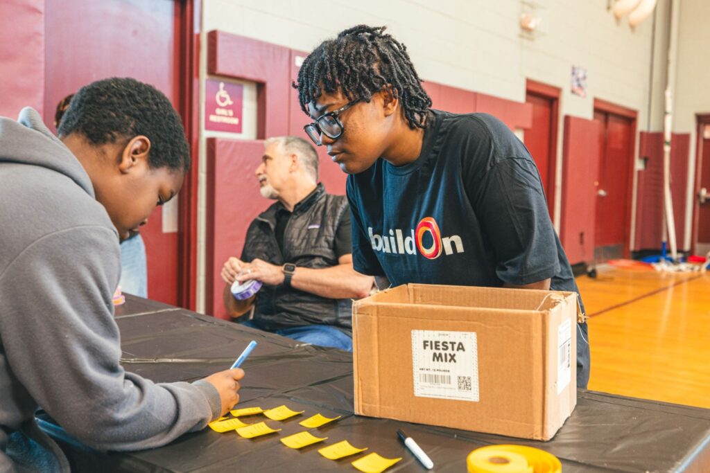 A buildOn student serves in Bridgeport at an Immersion with GE.