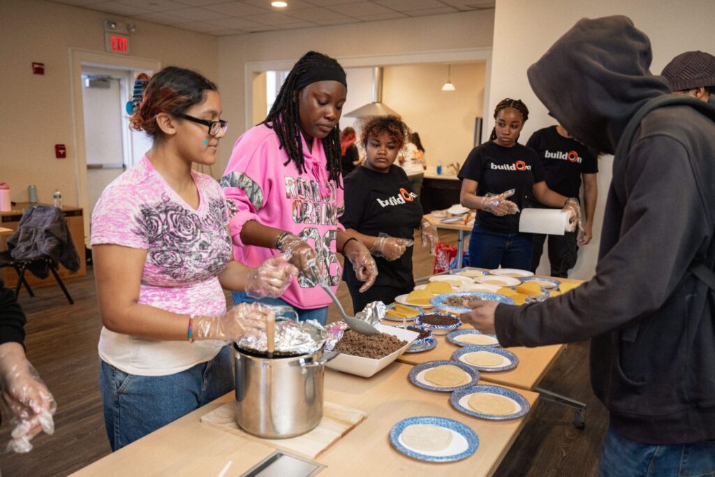 buildOn students help serve food at Harrison Apartments in Bridgeport. Food insecurity and financial issues often cause students to drop out.