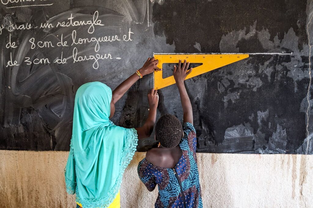 Students learning geometry at a buildOn school in Tamiougou, Burkina Faso.