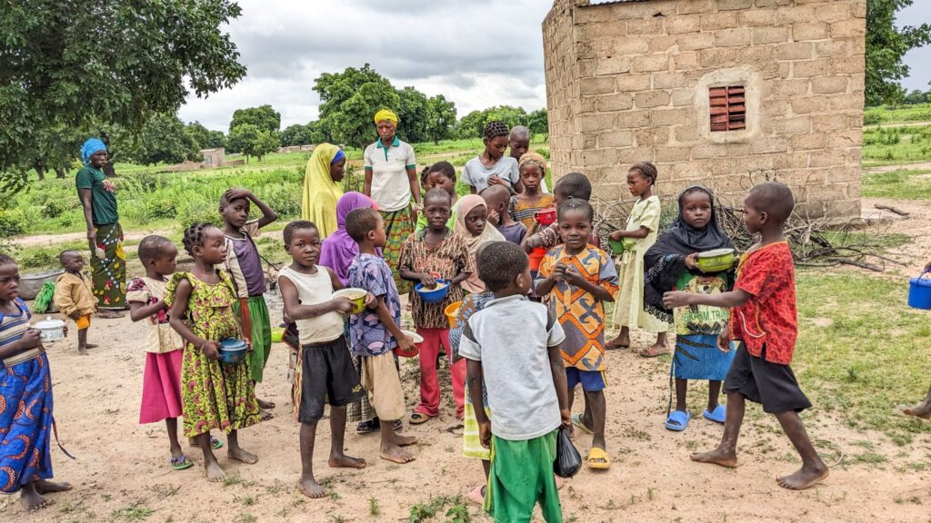 Children receiving a meal provided by Convoy of Hope in Roure.