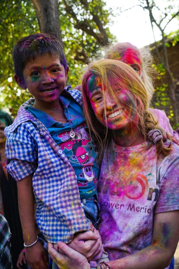 A Trek participant celebrates Holi in Nepal.