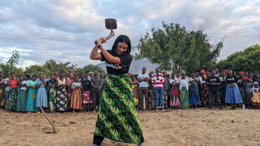 A trek participant helps break ground on a new school in Malawi.