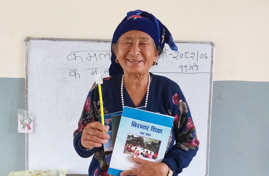 Aiso with her textbooks in her village’s buildOn-constructed school.