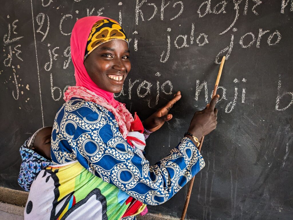 A woman learns how to write in a buildOn school in Bassa, Senegal.